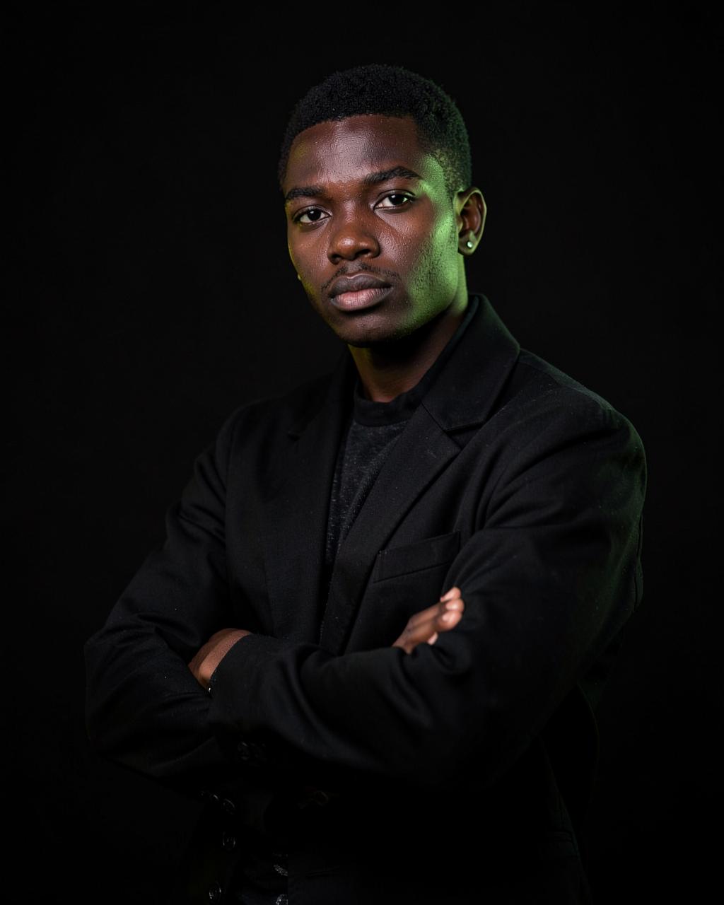 Portrait of Jace D. La Saint, creative director, in a dark studio